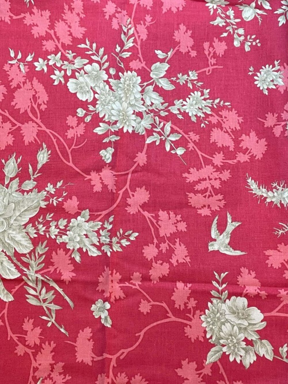 Notting Hill.  Tan floral fabric on muted red background.  Sold by the yard.